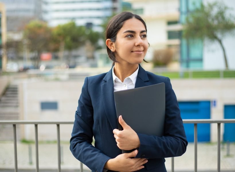 Happy businesswoman holding folder Happy businesswoman holding folder. Smiling young businesswoman in formal wear holding papers and looking aside on street. Professional occupation concept
